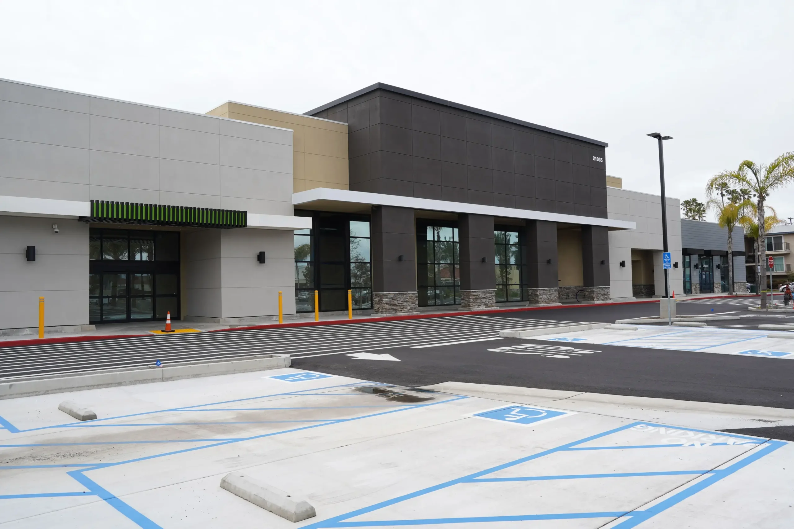 empty-parking-lot-in-the-daylight-with-a-modern-bu-2026-03-18-12-16-34-utc_1_50-4-scaled